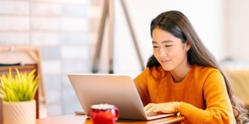 Women working on a laptop at a table